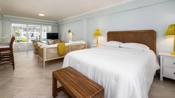 a bedroom with two beds and a large window