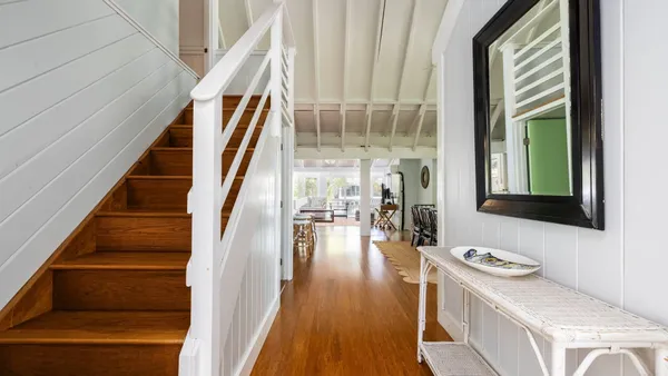 a view of an entryway with wooden floor and staircase