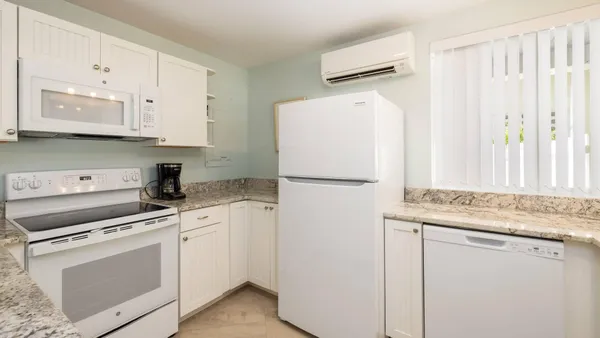 a kitchen with appliances a sink and a counter top space