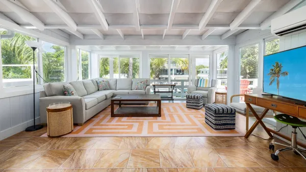 a living room with furniture a large window with outer view