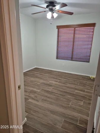 a bathroom with a granite countertop toilet sink and mirror