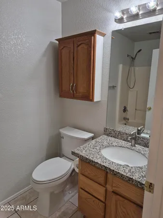 a view of a bathroom with a sink and a mirror