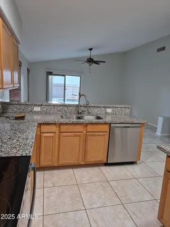 a kitchen with a stove a sink and a counter top space