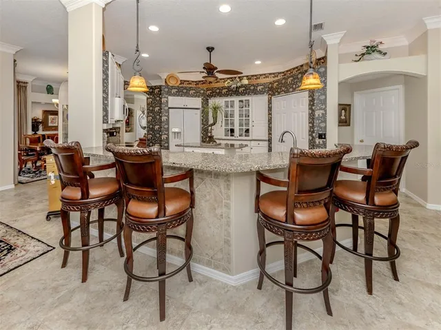 a view of a dining room and livingroom with furniture wooden floor a chandelier