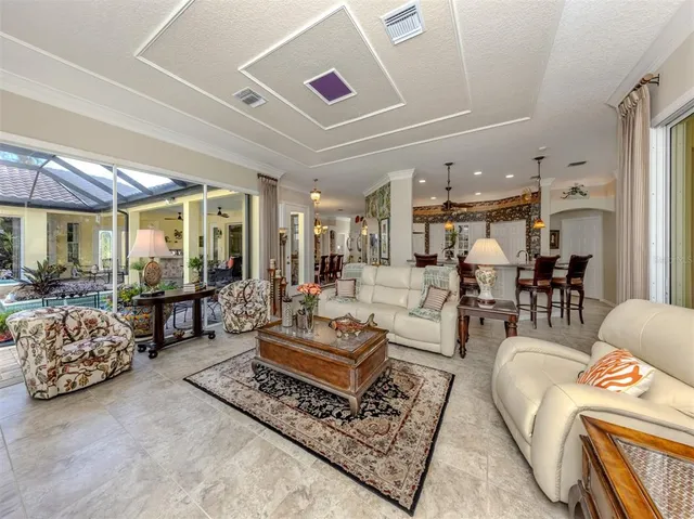 a kitchen with stainless steel appliances kitchen island granite countertop a sink and a refrigerator
