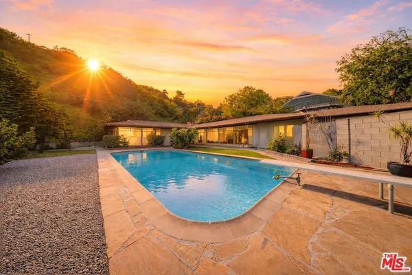 a view of a swimming pool with a patio