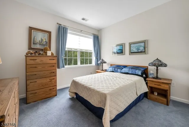 a bed sitting in a bedroom and dresser