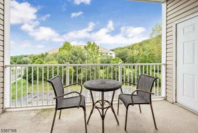a view of a chairs and table in the balcony