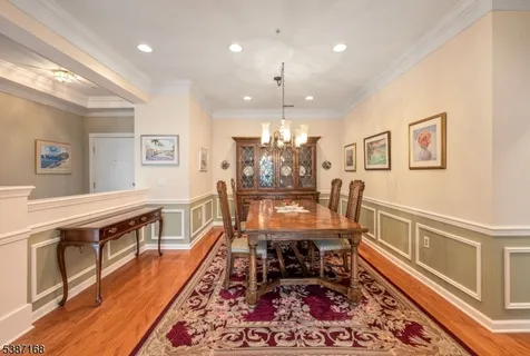 a dining room with wooden floor and furniture