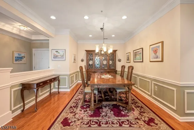 a dining room with wooden floor and furniture