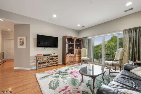 a bedroom with furniture and a flat screen tv