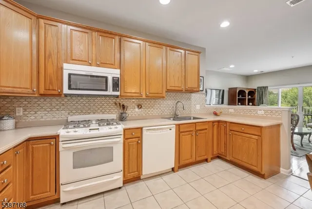 a kitchen with granite countertop cabinets stainless steel appliances and a window