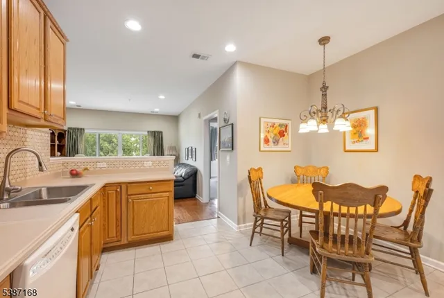 a kitchen with a sink dining table and chairs
