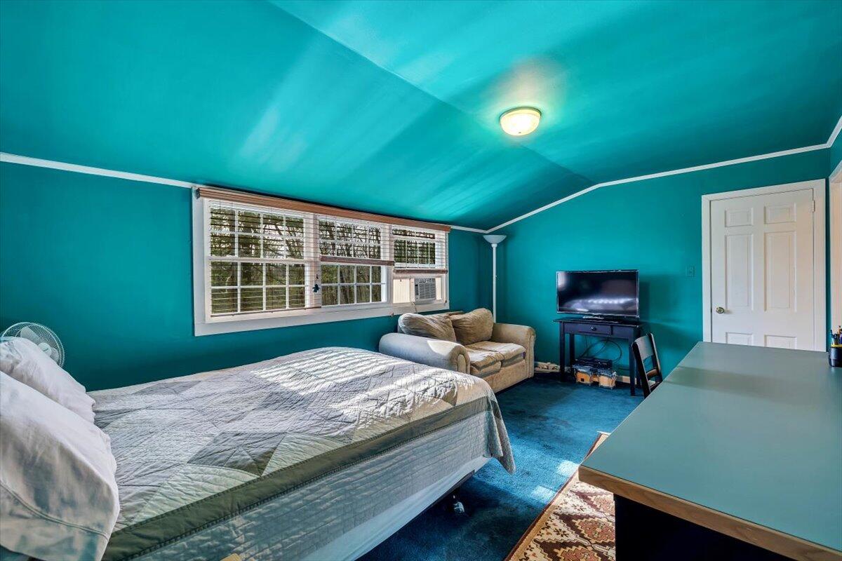 331 Summit Drive Cresco, PA 18326 - Photo 20 of 43 a bedroom with a bed and a flat tv screen on dresser