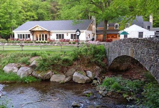 331 Summit Drive Cresco, PA 18326 - Photo 34 of 43 a front view of a house with a garden and trees