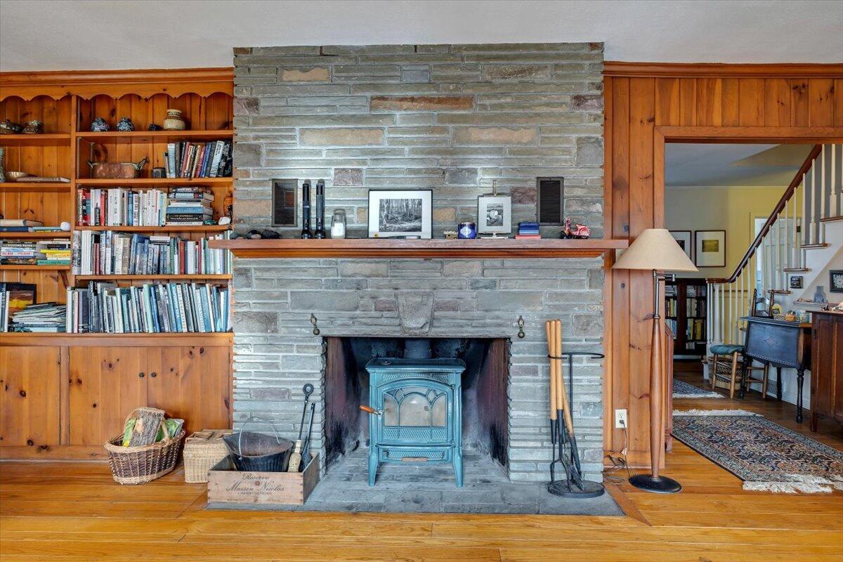 331 Summit Drive Cresco, PA 18326 - Photo 5 of 43 a living room with a fireplace and a book shelf