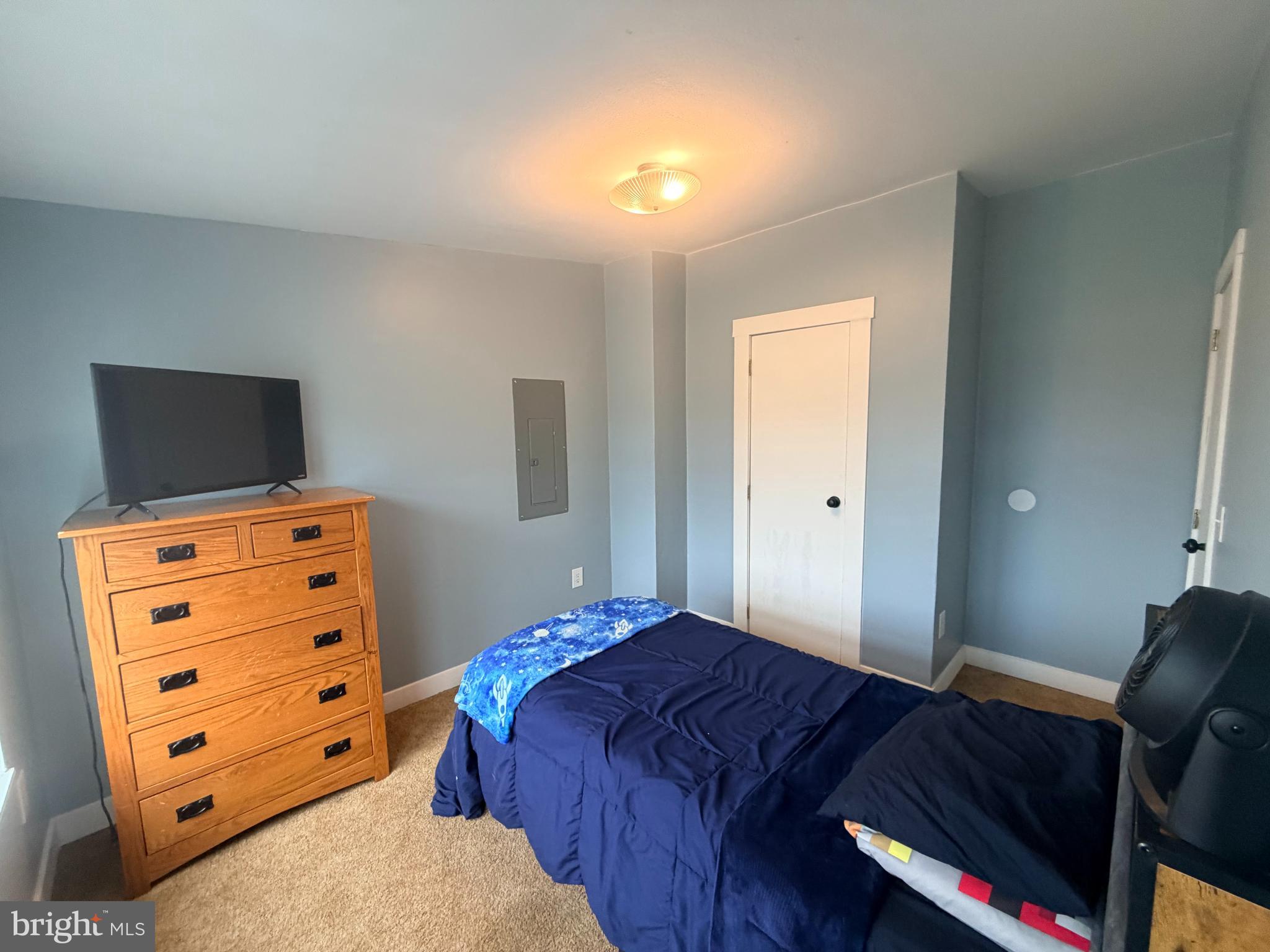 520 Wheeler School Road Whiteford, MD 21160 - Photo 15 of 37 a bedroom with a bed and a flat tv screen on dresser