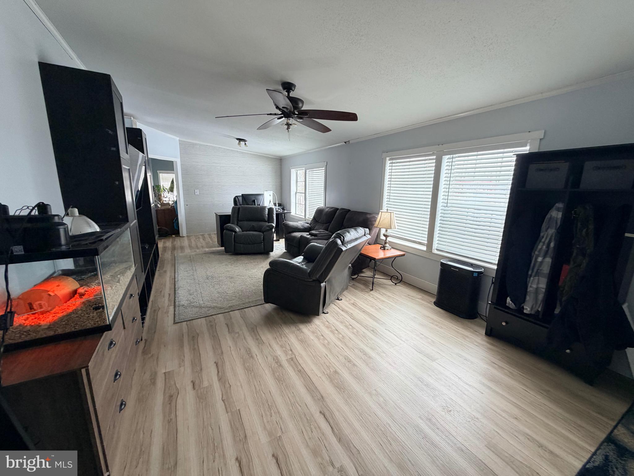 520 Wheeler School Road Whiteford, MD 21160 - Photo 2 of 37 a living room with furniture a flat screen tv and gym equipment