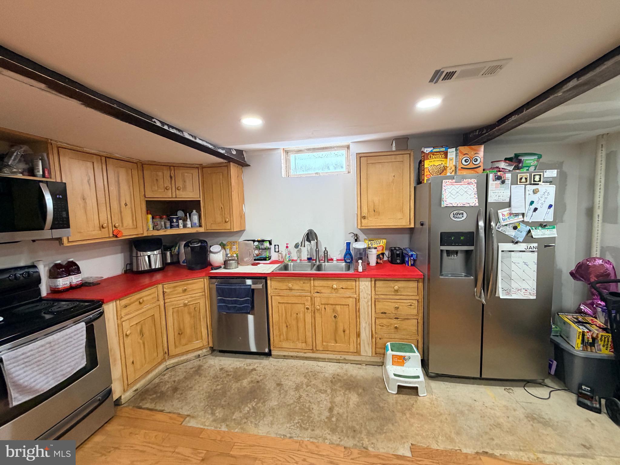 520 Wheeler School Road Whiteford, MD 21160 - Photo 30 of 37 a kitchen with stainless steel appliances kitchen island granite countertop a refrigerator and stove top oven