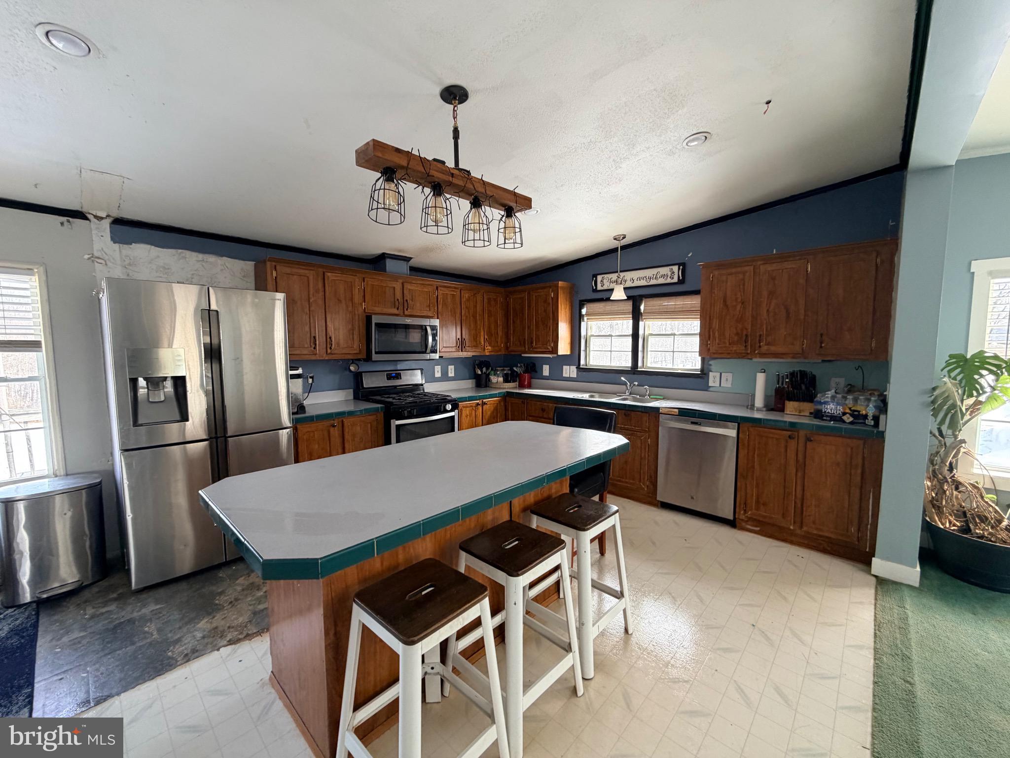 520 Wheeler School Road Whiteford, MD 21160 - Photo 10 of 37 a kitchen with stainless steel appliances granite countertop a sink a stove a refrigerator cabinets and a dining table