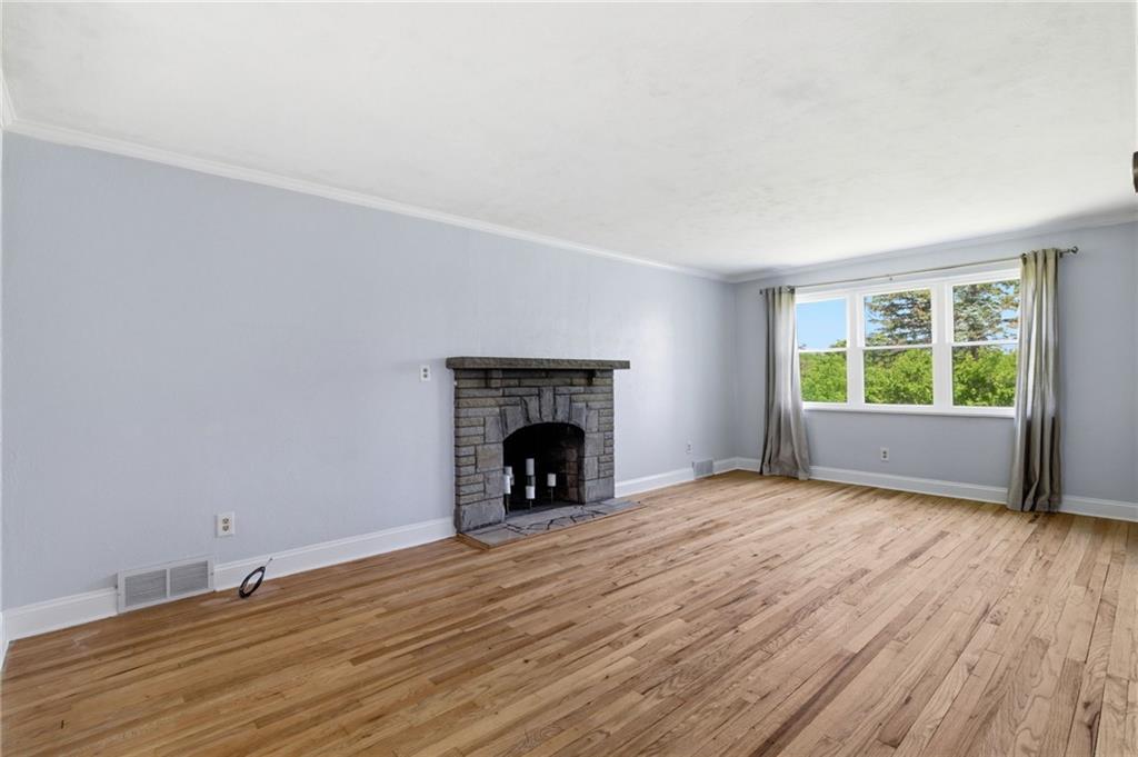 4883 East Willock Road Pittsburgh, PA 15227 - Photo 14 of 33 a view of an empty room with wooden floor fireplace and a window