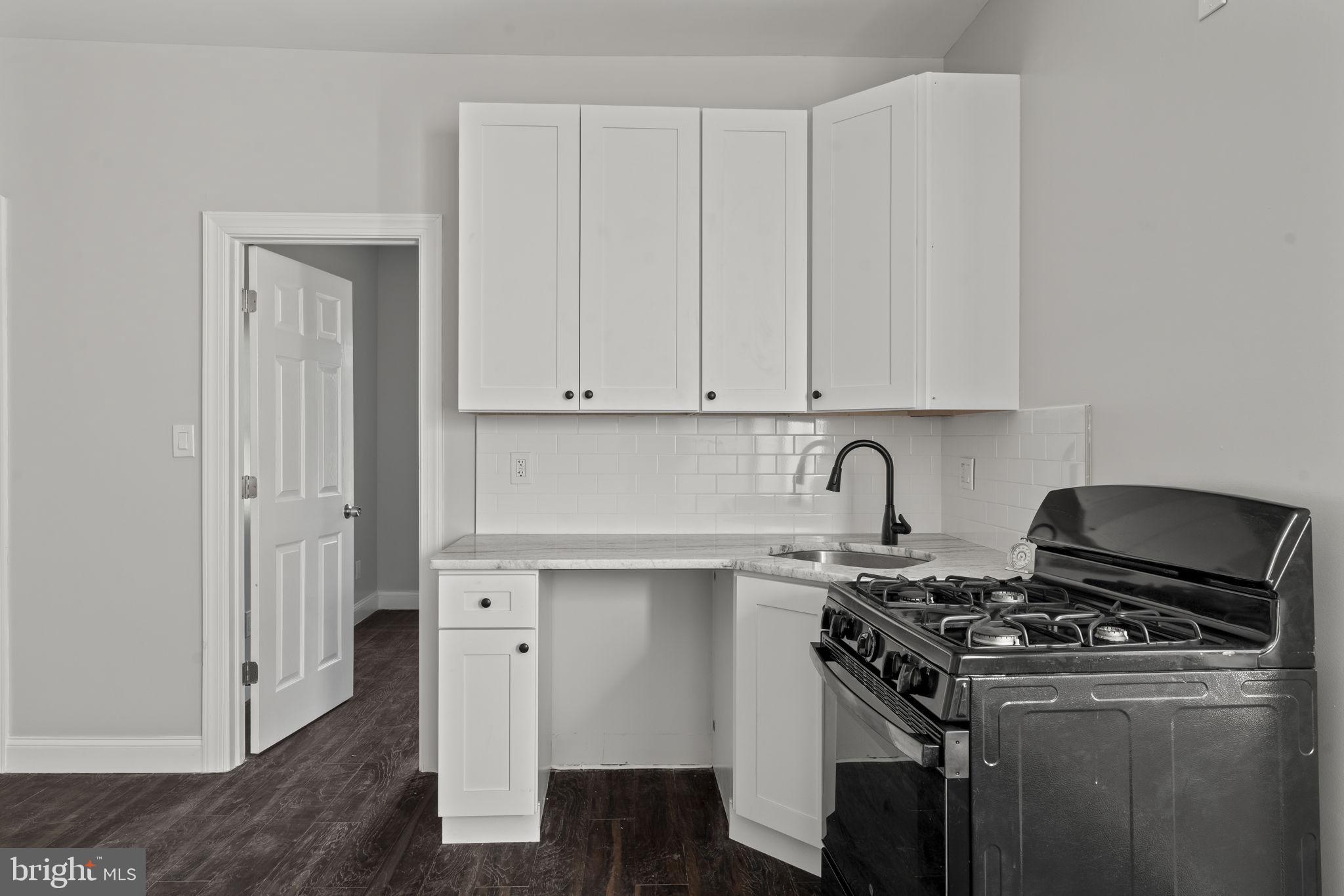 5237 Chester Avenue, Unit 2 Philadelphia, PA 19143 - Photo 18 of 40 a kitchen with stainless steel appliances granite countertop a stove and a refrigerator