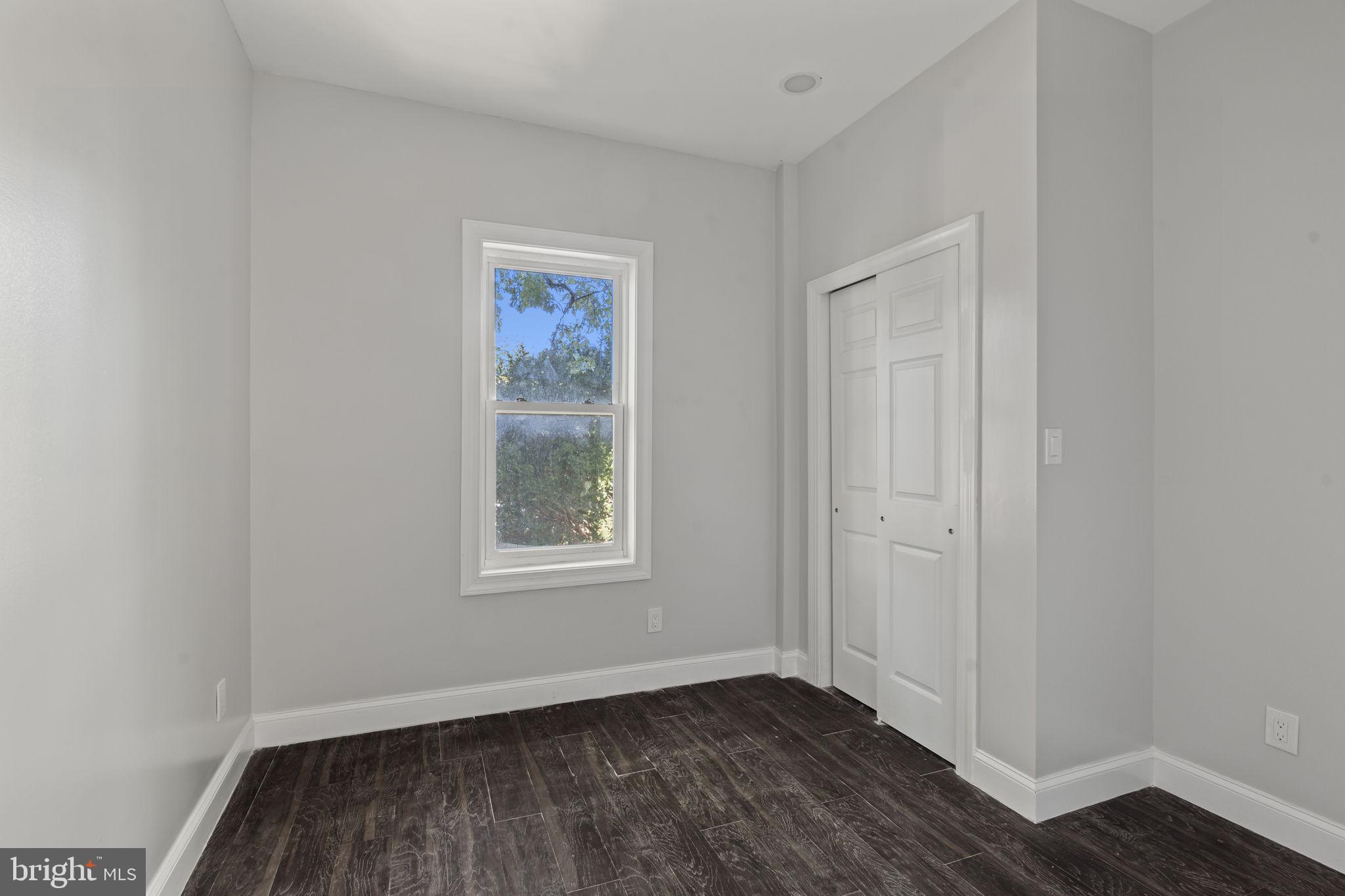 5237 Chester Avenue, Unit 2 Philadelphia, PA 19143 - Photo 21 of 40 an empty room with wooden floor and windows