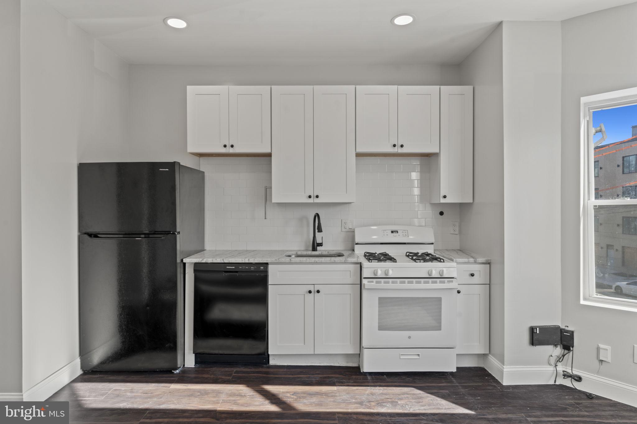 5237 Chester Avenue, Unit 2 Philadelphia, PA 19143 - Photo 24 of 40 a kitchen with a stove sink and refrigerator