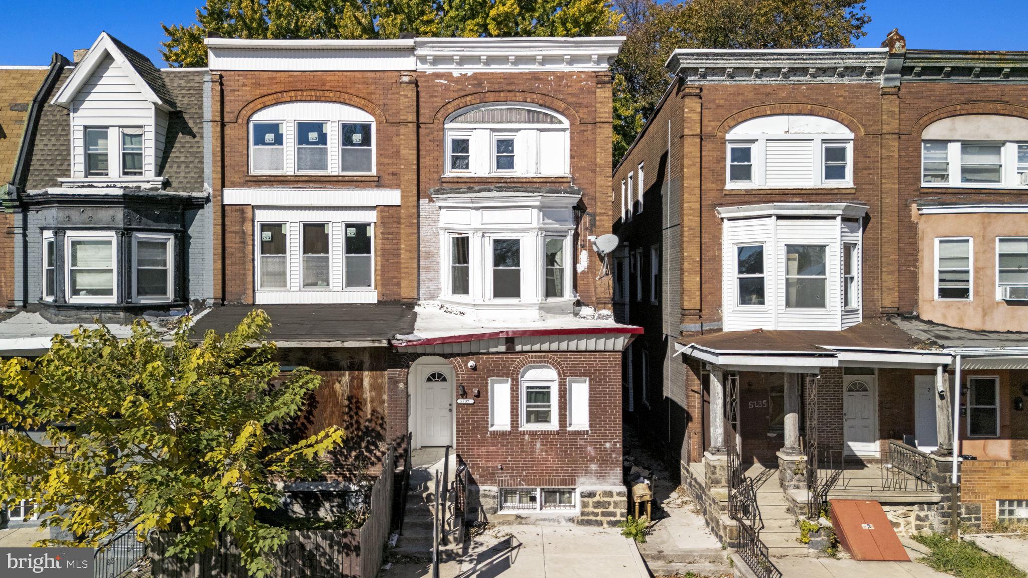 5237 Chester Avenue, Unit 2 Philadelphia, PA 19143 - Photo 6 of 40 a front view of a residential apartment building with a yard