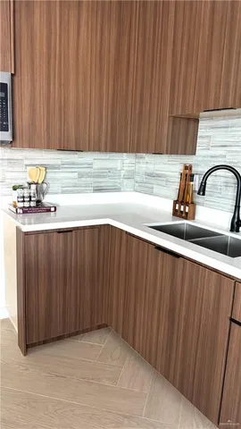 a kitchen with a sink and cabinets
