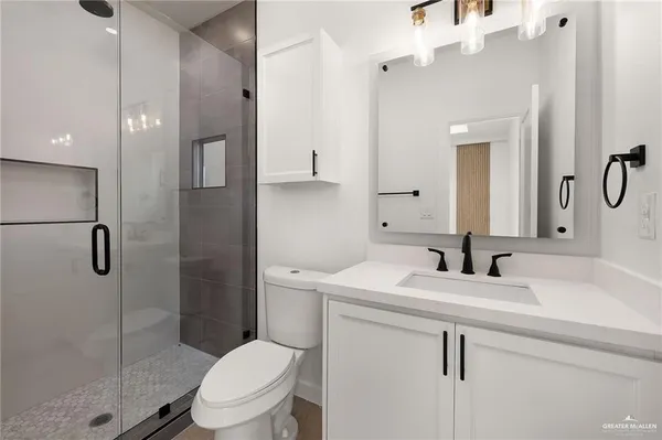 a bathroom with double sink and a mirror