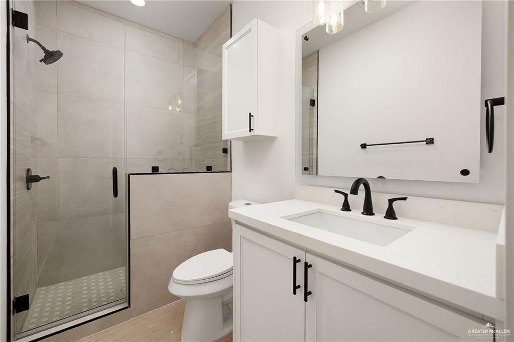 2901 Estevan Street, Unit 4 Mission, TX 78574 - Photo 25 of 27 a bathroom with a sink toilet and shower