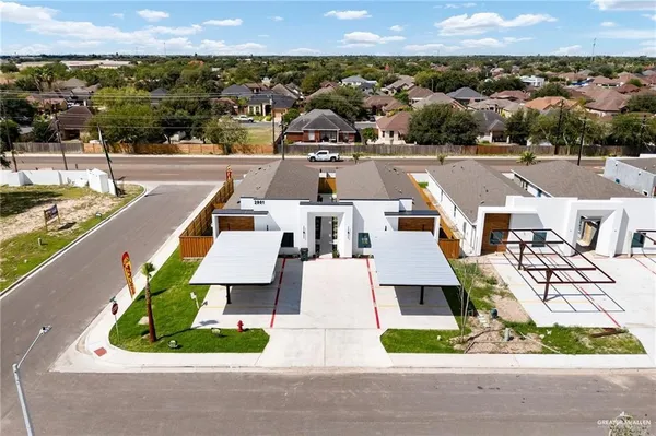 an aerial view of a house with a garden and lake view
