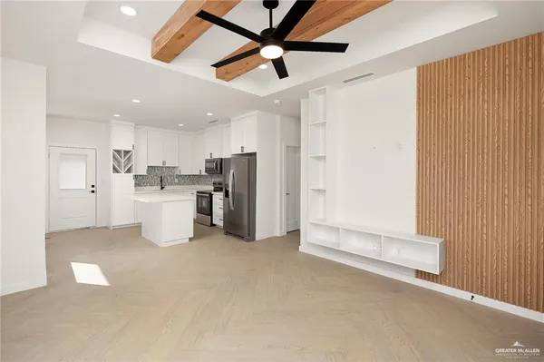 a view of a kitchen with refrigerator and a ceiling fan
