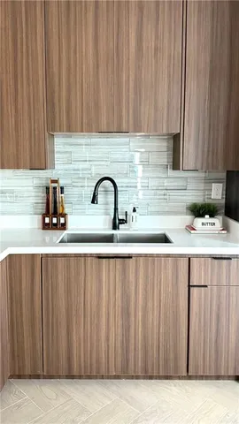 a kitchen with a sink cabinets and appliances