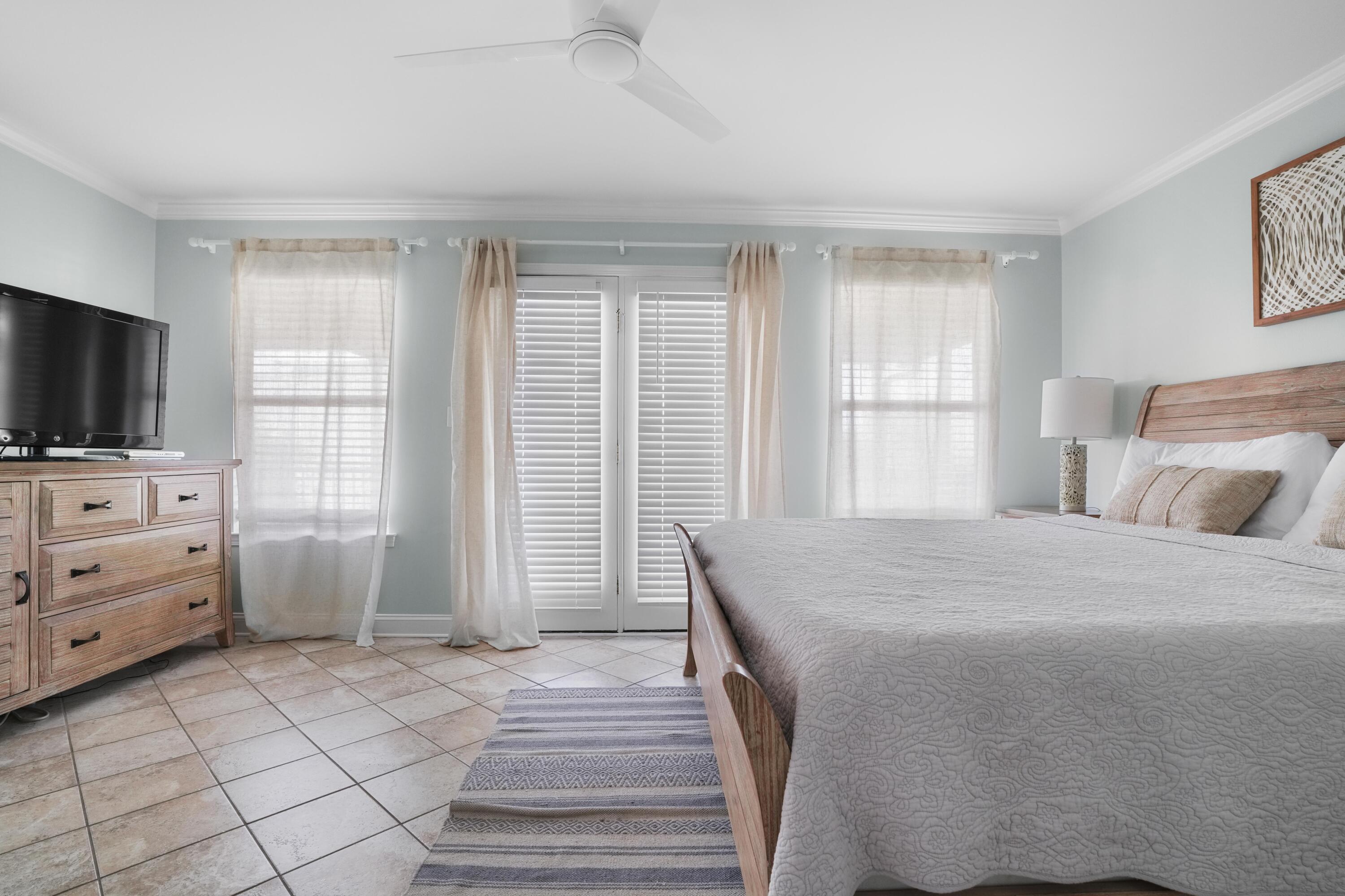 12 Windancer Lane Miramar Beach, FL 32550 - Photo 24 of 42 a bedroom with a bed and flat screen tv