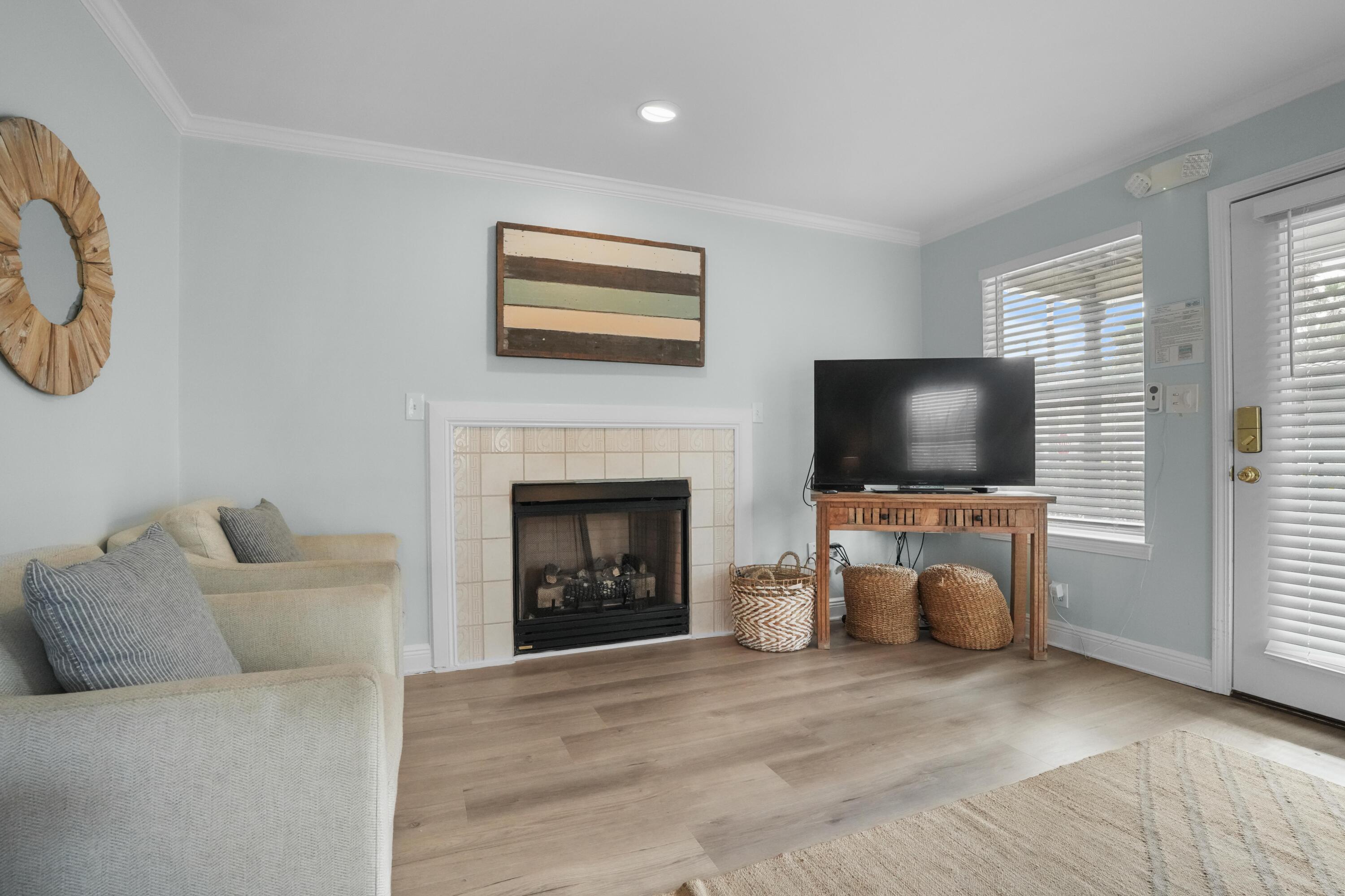 12 Windancer Lane Miramar Beach, FL 32550 - Photo 7 of 42 a living room with furniture a flat screen tv and a fireplace