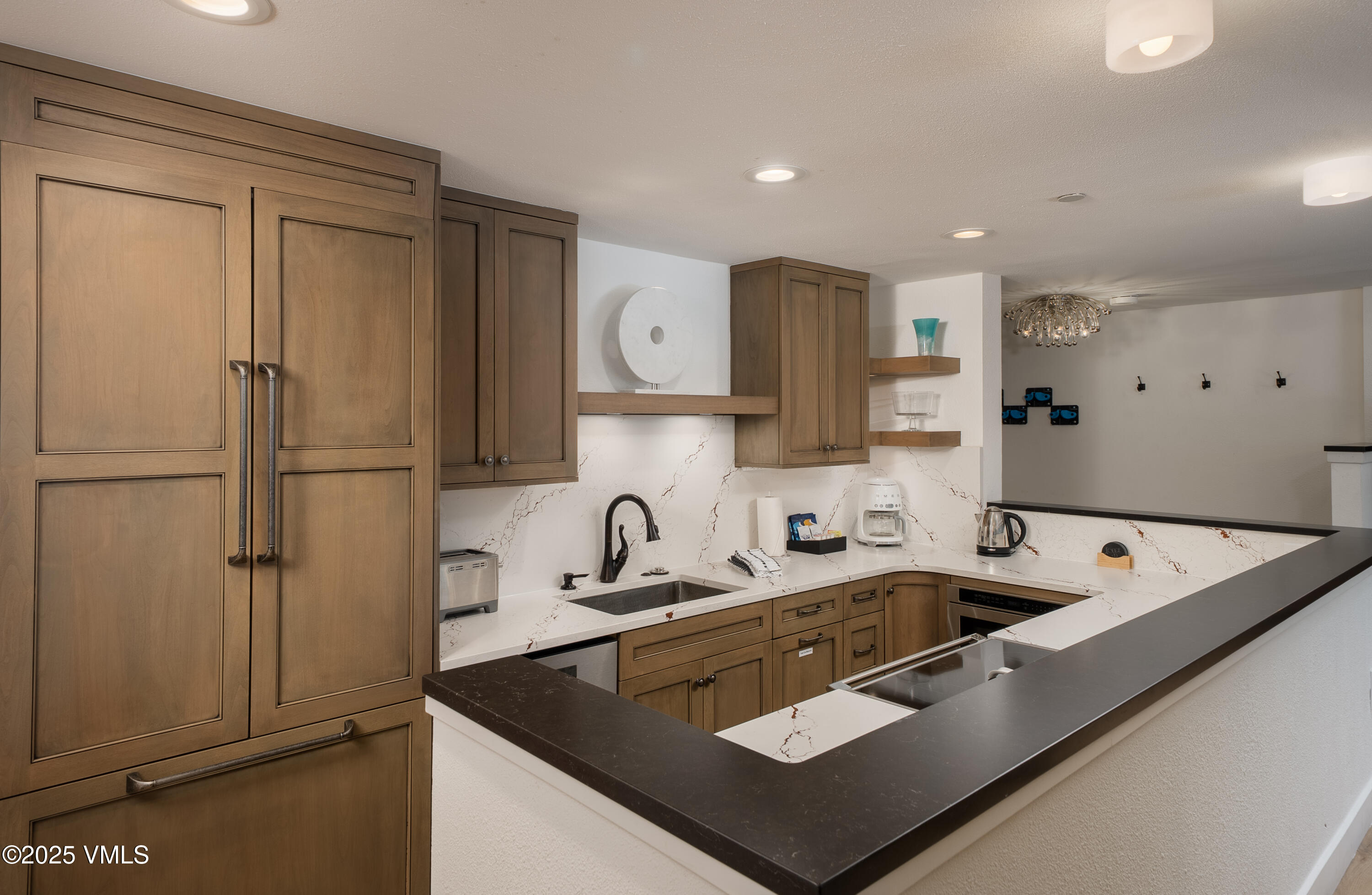 120 Willow Bridge Road, Unit 2H Vail, CO 81657 - Photo 3 of 15 a kitchen with stainless steel appliances granite countertop a sink refrigerator and cabinets