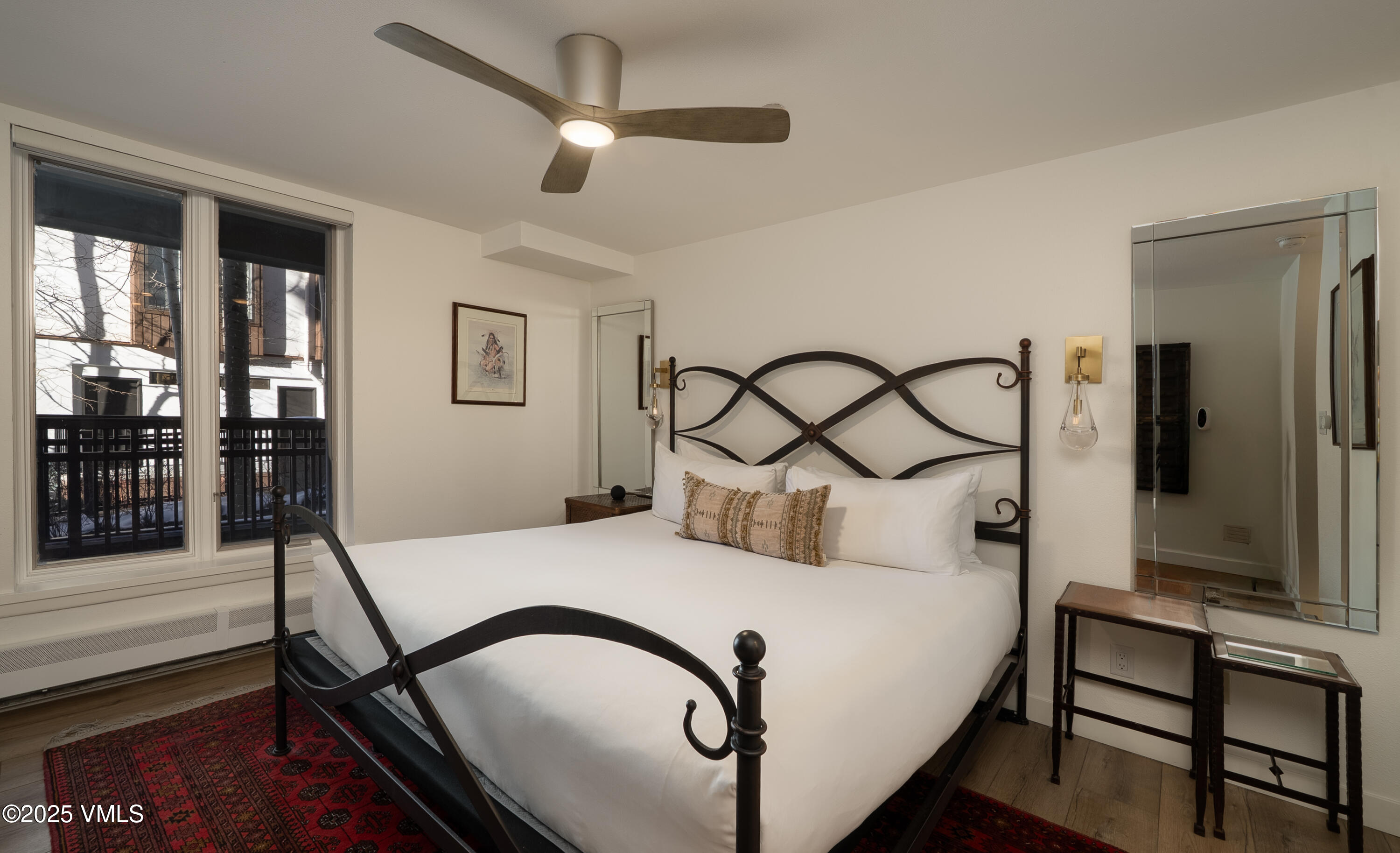 120 Willow Bridge Road, Unit 2H Vail, CO 81657 - Photo 6 of 15 a bedroom with a bed and a chandelier