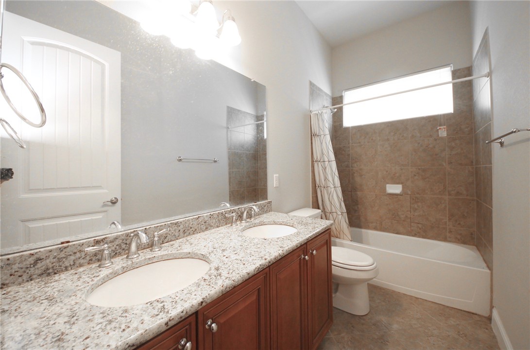 15800 Jeffs Lane Austin, TX 78717 - Photo 11 of 17 a bathroom with a granite countertop sink toilet and shower