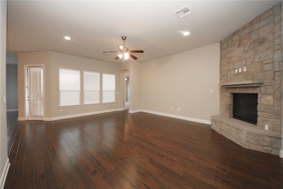 15800 Jeffs Lane Austin, TX 78717 - Photo 5 of 17 a view of an empty room with wooden floor and a fireplace