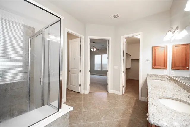 a bathroom with a tub and shower