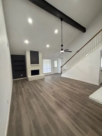wooden floor in an empty room with a kitchen