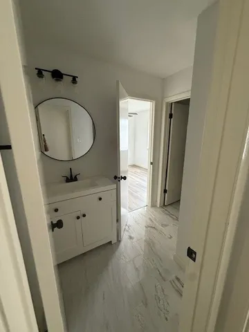 a bathroom with mirror and window