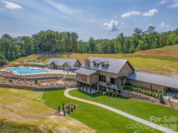 an aerial view of a house with swimming pool garden and outdoor seating