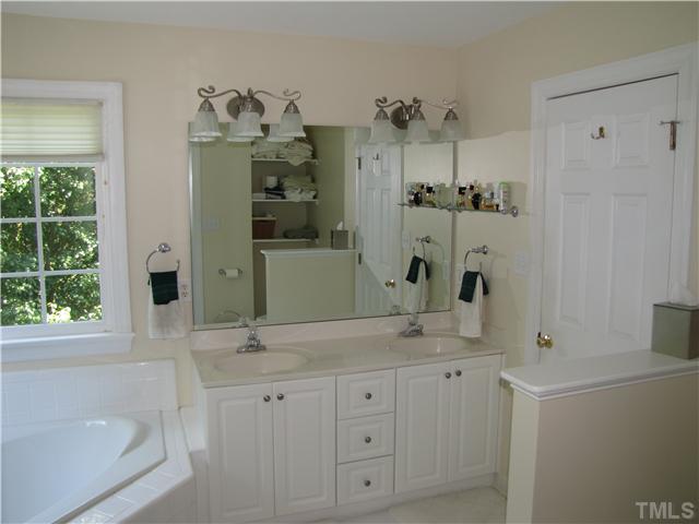 12101 Old Creedmoor Road Raleigh, NC 27613 - Photo 8 of 25 a bathroom with a granite countertop sink and a mirror