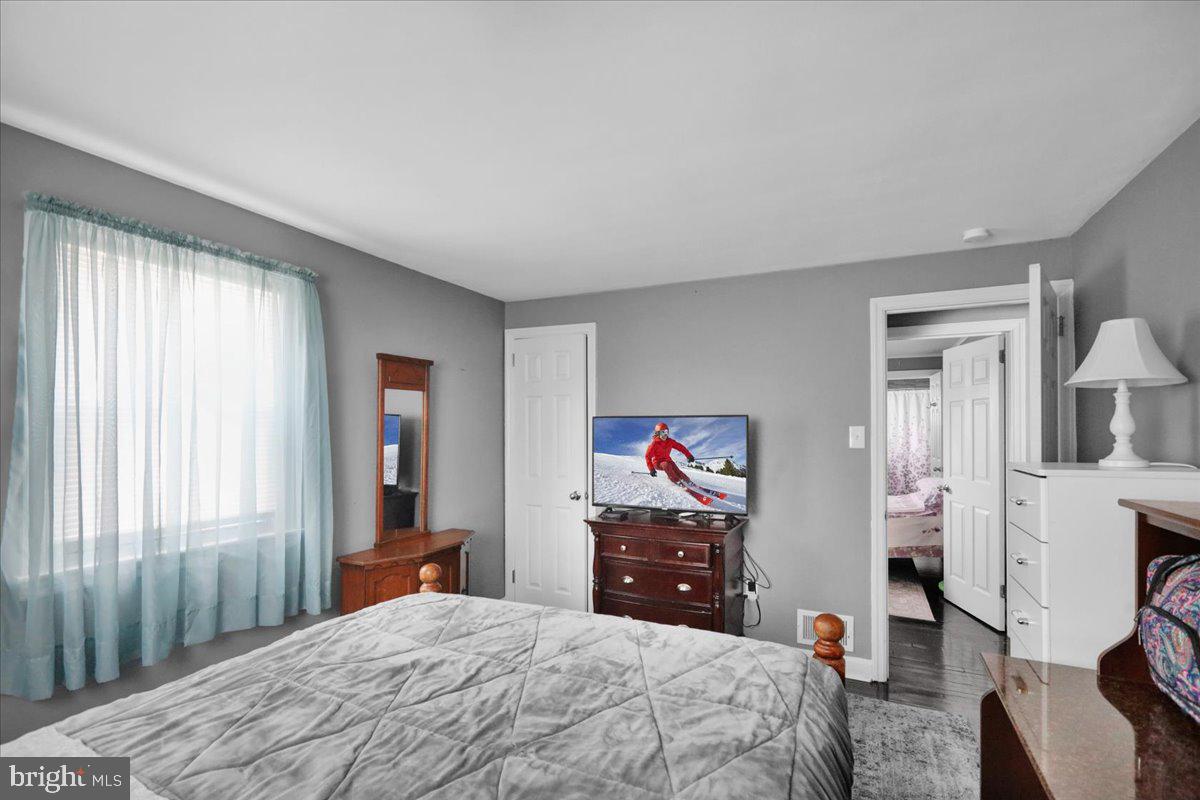 135 Chestnut Street Shillington, PA 19607 - Photo 19 of 34 a bedroom with a bed and a chandelier