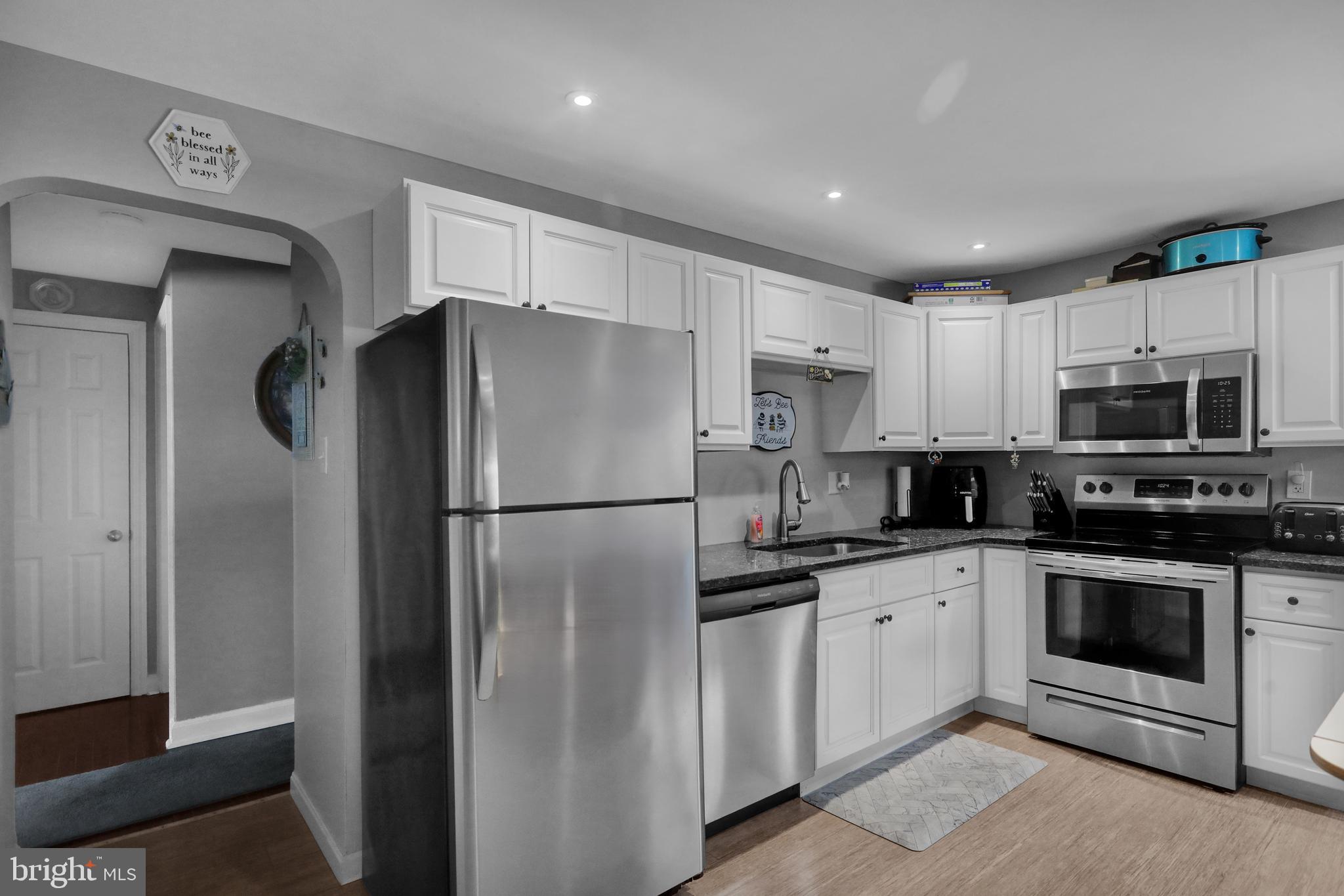 135 Chestnut Street Shillington, PA 19607 - Photo 8 of 34 a kitchen with stainless steel appliances granite countertop a refrigerator sink and microwave