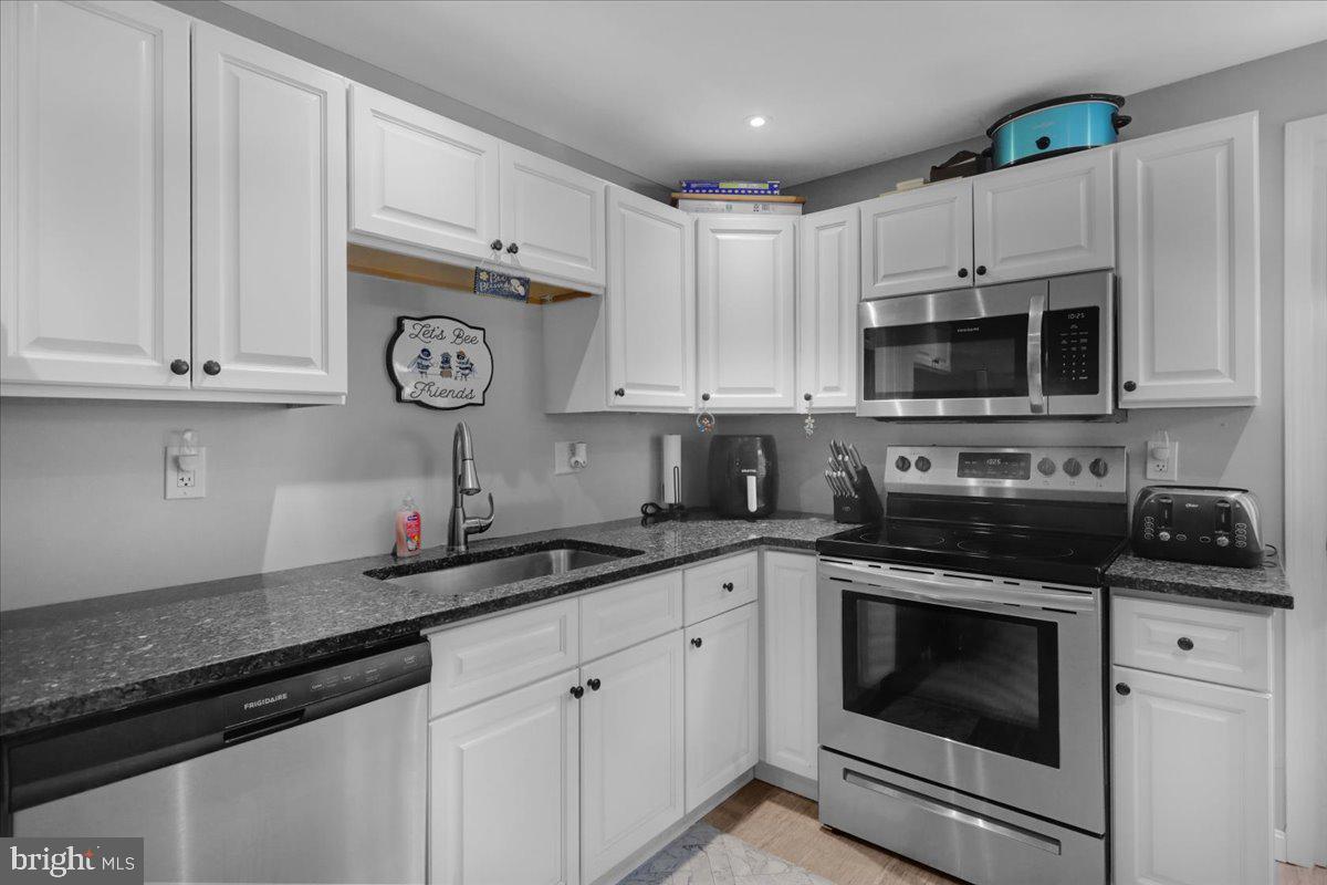 135 Chestnut Street Shillington, PA 19607 - Photo 10 of 34 a kitchen with cabinets stainless steel appliances a sink and a stove