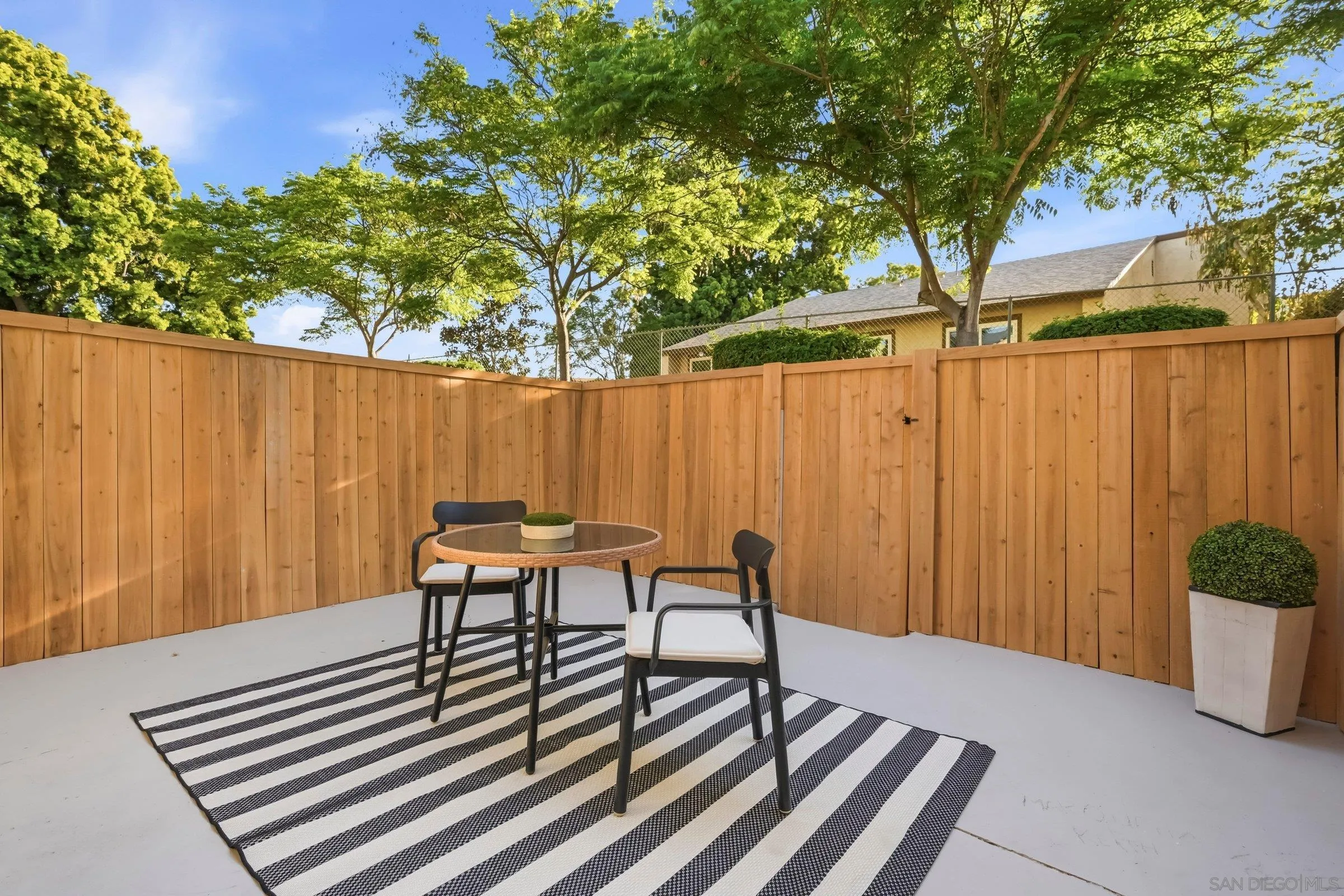 458 Ridgeway Court Spring Valley, CA 91977 - Photo 25 of 26 a view of a backyard with a table and chairs with wooden fence and plants